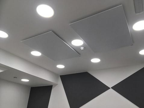 Herschel white panels ceiling mounted in office space